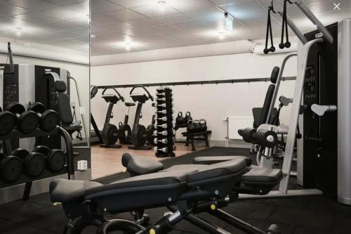 a gym with several treadmills and machines at Shared Modern apartment with pets by the waterfront in Stockholm