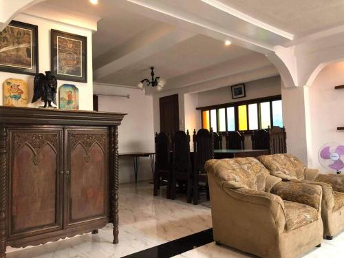 a living room with a couch and a table at Heart of Paete Laguna, Camarero Transient House in Paete
