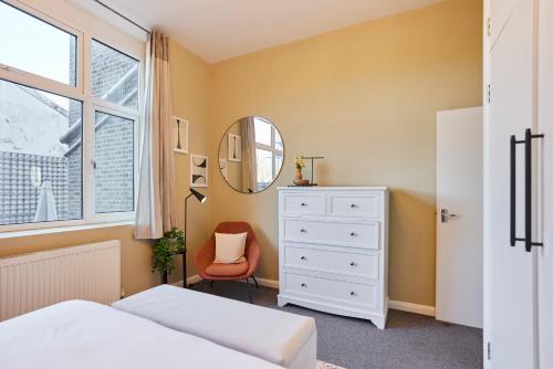 a bedroom with a white dresser and a mirror at The Crystal Palace Crib - Lovely 1BDR Flat in Crystal Palace