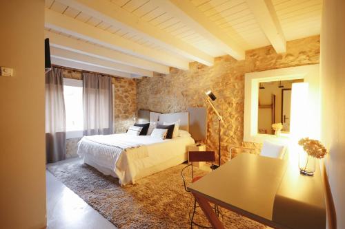 a bedroom with a bed and a table in it at Hotel Garaiko Landetxea in Durango