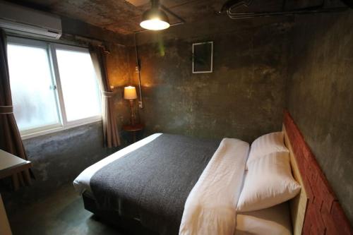 a bedroom with a bed and two windows at How are you here in Hongdae in Seoul