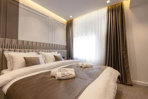 a bedroom with two beds with towels on them at RIVA sleep & chill in Valjevo