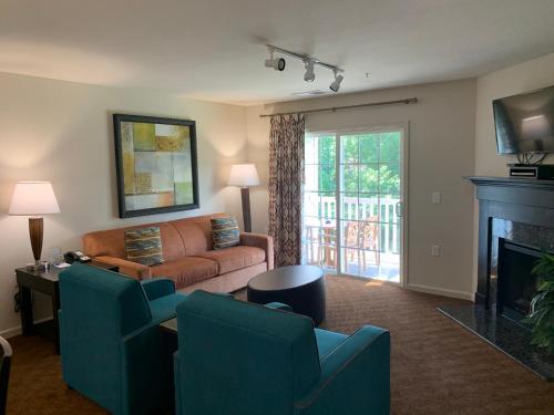 a living room with a couch and a fireplace at The Colonies at Williamsburg in Williamsburg