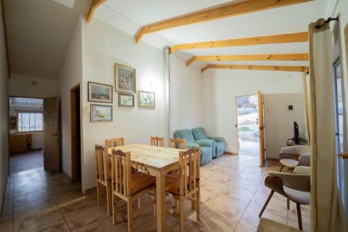 a kitchen and dining room with a table and chairs at Refugio Noche Andina in Vicuña
