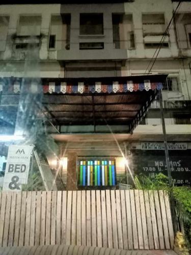 Muster Guesthouse في فرا ناخون سي أيوتثايا: مبنى ذو واجهة متجر بنافذة ملونة