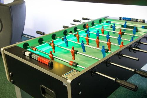 a foosball table with toy people on it at Europejski Boutique Hotel in Radom