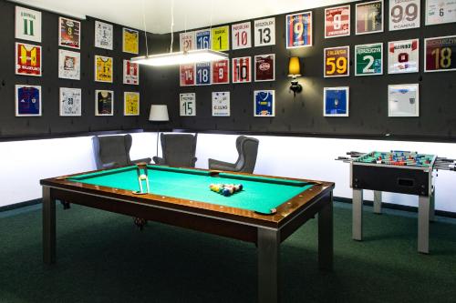 a ping pong table in a room with pictures on the wall at Europejski Boutique Hotel in Radom
