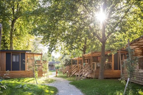 a row of log cabins in the woods with trees at CityKamp Paris in Paris