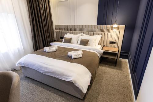 a hotel room with two beds with towels on them at RIVA sleep & chill in Valjevo