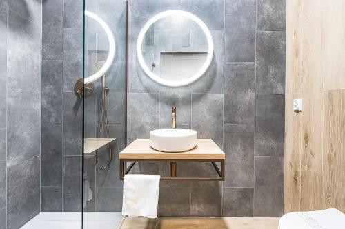 a bathroom with a sink and a mirror at Europejski Boutique Hotel in Radom