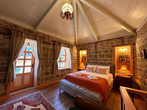 a bedroom with a bed and a chandelier at Orion Adatepe in Adatepe