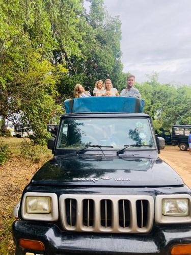 a group of people sitting on the roof of a jeep at Shan Mango Homestay in Sigiriya