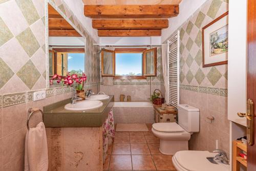 a bathroom with a sink and a toilet and a tub at Villa Els Amatllers by Sealand Villas in Port de Pollensa