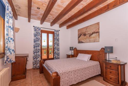 a bedroom with a bed and a window at Villa Els Amatllers by Sealand Villas in Port de Pollensa