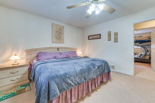 a bedroom with a bed and a ceiling fan at Secluded Mancelona Home with Gas Grill! in Mancelona
