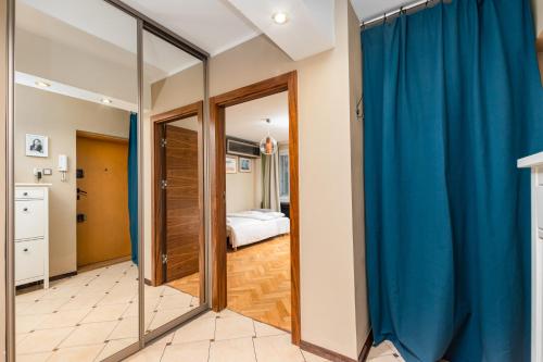 a room with blue curtains and a bedroom at Apartament Topiel by Your Freedom in Warsaw