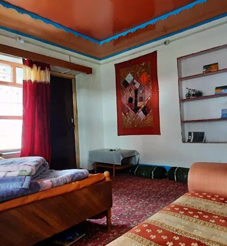 a bedroom with a bed and a couch in it at Gurez Retreat in Kanzalwan