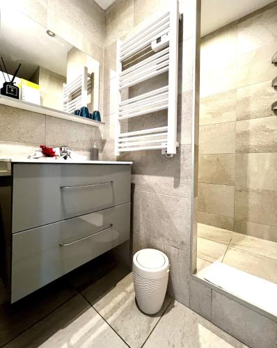 a bathroom with a sink and a toilet and a shower at Hotel L'Escapade in Le Lavandou