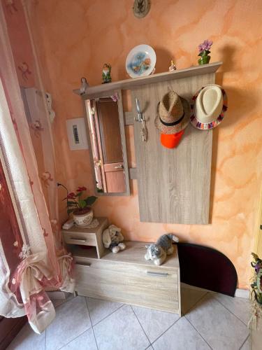 a doll house with a hat on the wall at Sweet Home Rosy in Calatabiano