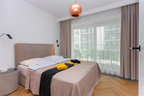 a bedroom with a bed and a large window at Yacht Park Marina in Gdynia