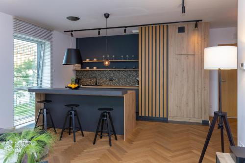 a kitchen with a blue counter and bar stools at Yacht Park Marina in Gdynia