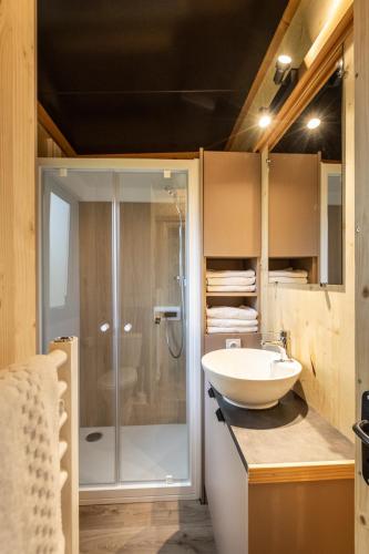 a bathroom with a glass shower and a sink at CityKamp Paris in Paris