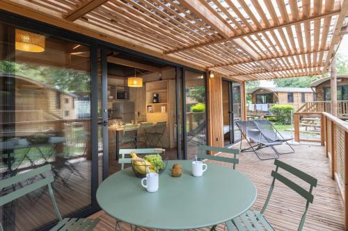 a patio with a table and chairs on a deck at CityKamp Paris in Paris