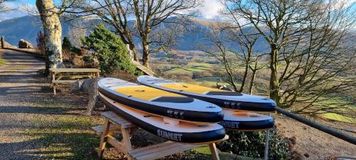 a row of kayaks sitting on top of a bench at Scafell and Wasdale Cottages in Nether Wasdale