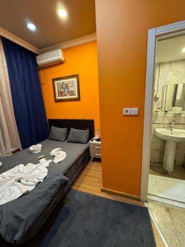a bedroom with a bed and a bathroom with a sink at Taksim Pandora hotel in Istanbul