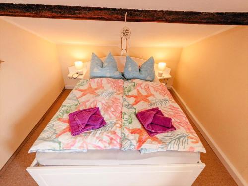 a bedroom with a large bed with blue pillows at W3 - Urlaubsmagie - Maisonette-Wohnung mit Pool in Lichtenhain
