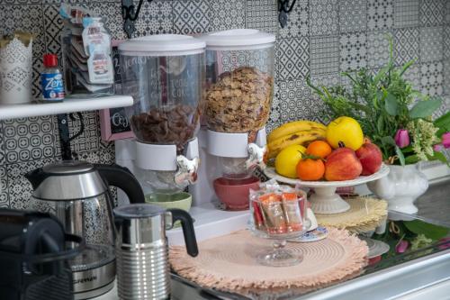 a kitchen counter with a bowl of fruit and other food at B&B Carpe Diem in Castel Gandolfo