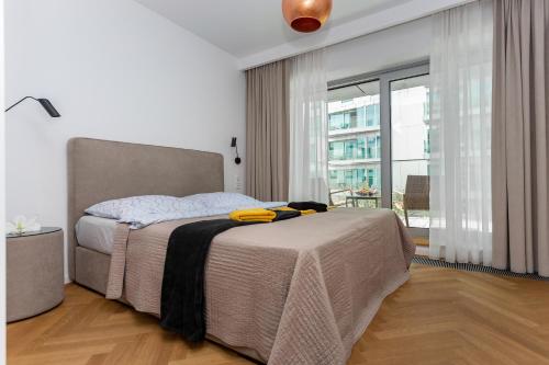 a bedroom with a bed and a large window at Yacht Park Marina in Gdynia
