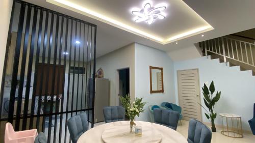 a dining room with a table and blue chairs at DD Homestay Pasir Gudang in Pasir Gudang
