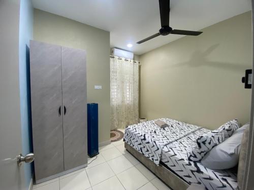 a small bedroom with a bed and a closet at DD Homestay Pasir Gudang in Pasir Gudang