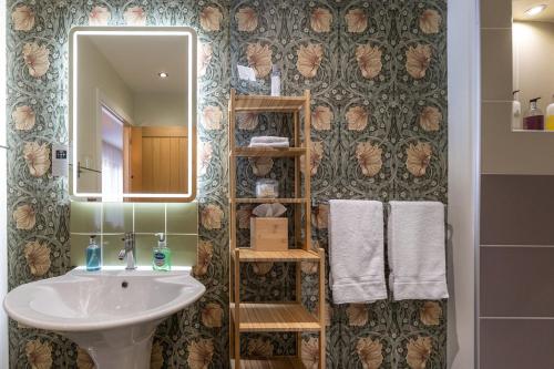 a bathroom with a sink and a mirror at Broad Bay House in Stornoway