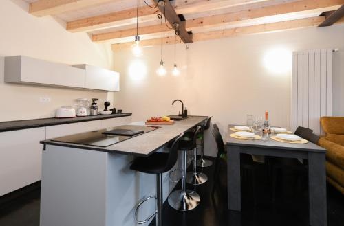 a kitchen with a counter and a island in a room at Casa Margherita - new house in the ancient hamlet in Salò