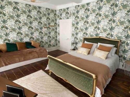 een slaapkamer met een bed en een bank bij Gîte et SPA La Poterne in Bergues