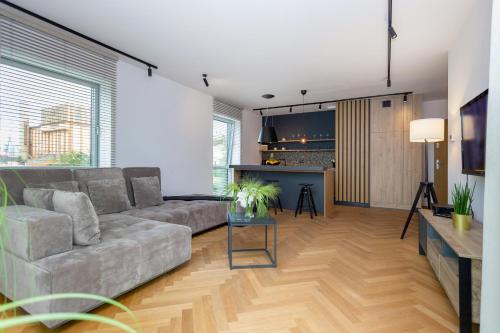a living room with a couch and a table at Yacht Park Marina in Gdynia