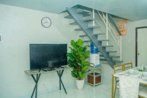 a staircase in a living room with a table and a desk at Matina Pangi Evisa Subdivision 2 bedrooms house with parking wifi Netflix in Davao City