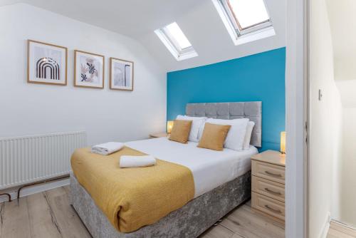 a bedroom with a large bed with a blue wall at Air Host and Stay - St Davids House Lovely 4 bedroom house 2 bathrooms in Liverpool