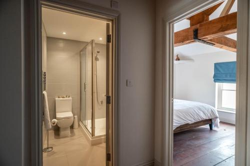 a bathroom with a shower and a toilet in a room at The Old Custom House in Poole