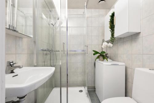 a white bathroom with a toilet and a sink at Large apartment - Luxurious neighborhood - 8 pax in Oslo