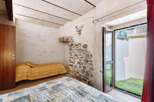 a bedroom with a bed and a window at Casa Vacanze Laghi e Monti in Mergozzo
