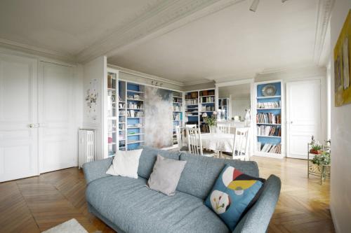 un soggiorno con divano blu e tavolo di Spacious apartment with 3 bedrooms - Tour Eiffel a Parigi