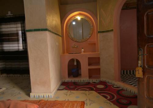 a bathroom with a sink and a mirror at Casa Laman in Merzouga