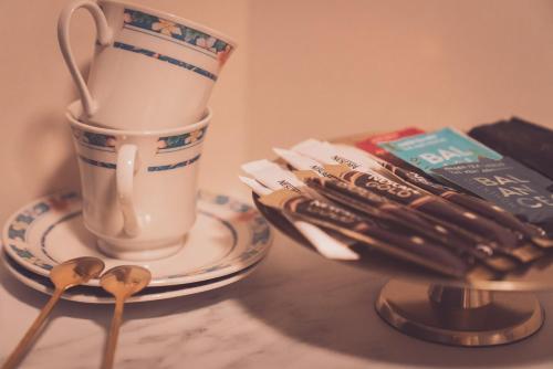 a cup of coffee sitting on a table with spoons at Villa Havblikk Tromsø in Tromsø