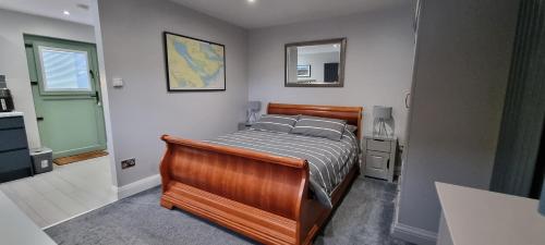 a bedroom with a wooden bed in a room at The Nook in Rostrevor