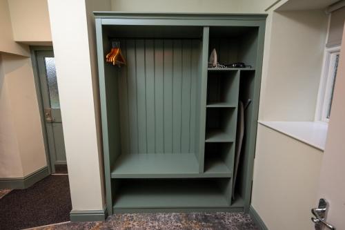 a green cabinet in a room at Rockingham Arms By Greene King Inns in Wentworth