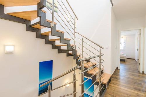 a staircase in a home with white walls and wood floors at Villa Miri Rosemary in Privlaka