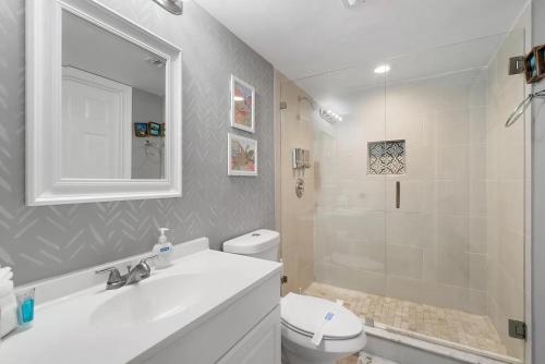 塔維涅的住宿－Tropical Getaway w/Private Beach 1 BD Condo，一间带水槽、卫生间和淋浴的浴室